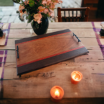 The Cherry wooden serving tray with natural wood grain, red inlays, dark borders, and black handles, without engraving